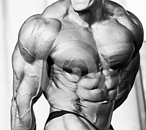 Bodybuilder athlete torso. Black and white photo