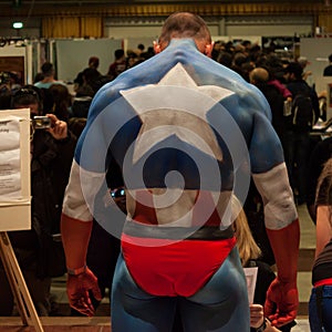 Bodybuilder during a body painting session at Milano Tattoo Convention