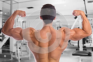 Bodybuilder bodybuilding flexing muscles posing gym back biceps