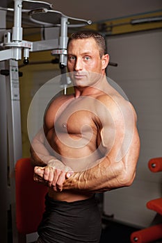 Bodybuilder demonstrating pose in fitness club