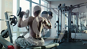 The bodybuilder does exercises for a back
