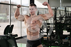 Bodybuilder Fitness Model Posing Double Biceps After Exercises