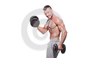 Bodybuilder guy doing exercises with dumbbells