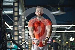 Bodybuilder guy in gym pumping up hands close up