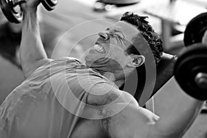 Bodybuilder hard training in the gym