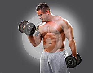 Bodybuilder lifting dumbbells, closeup 2