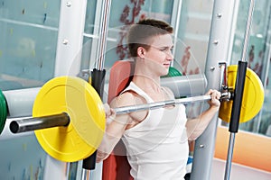 Bodybuilder man doing biceps muscle exercises photo