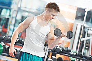 Bodybuilder man doing biceps muscle exercises