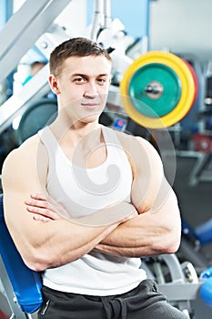 Bodybuilder man doing biceps muscle exercises photo