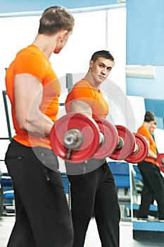 Bodybuilder man doing biceps muscle exercises