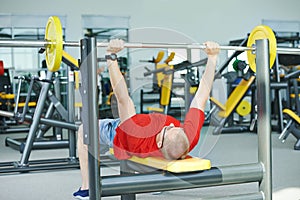 Bodybuilder man doing muscle exercises with weight