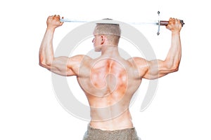 Bodybuilder man posing with a sword isolated on white background. Serious shirtless man demonstrating his mascular body