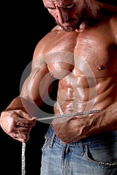 Bodybuilder man with tape measure