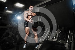 Bodybuilder muscle Athlete training with weight in gym