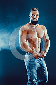 Bodybuilder posing. Beautiful sporty guy male power.