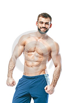 Bodybuilder posing. Beautiful sporty guy male power. Fitness muscled in blue shorts. on isolated white background. Man