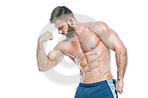 Bodybuilder posing. Beautiful sporty guy male power. Fitness muscled in blue shorts. on isolated white background. Man