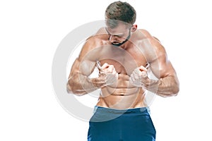 Bodybuilder posing. Beautiful sporty guy male power. Fitness muscled in blue shorts. on isolated white background. Man