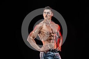 Bodybuilder posing. Beautiful sporty guy male power.