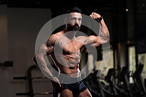 Bodybuilder Posing Biceps After Exercises