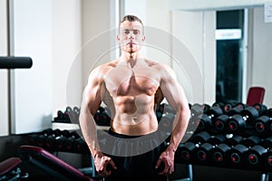 Bodybuilder posing in Gym