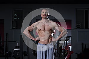 Bodybuilder posing in gym, perfect muscular male body