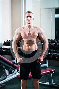 Bodybuilder posing in Gym