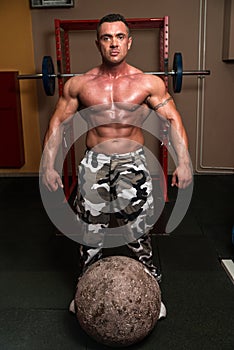 Bodybuilder Resting After Picking Up A Stone