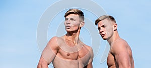 Bodybuilder shape. Men muscular athlete bodybuilder show muscles. Men muscular chest naked torso stand sky background