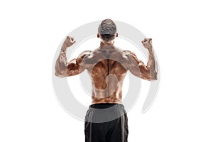 Bodybuilder showing his back and biceps muscles isolated on a white background, personal fitness trainer.