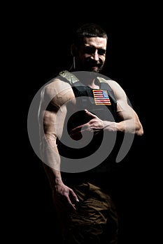 Bodybuilder Soldier With Bulletproof Vest on Black Background