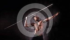 Bodybuilder throwing javelin photo