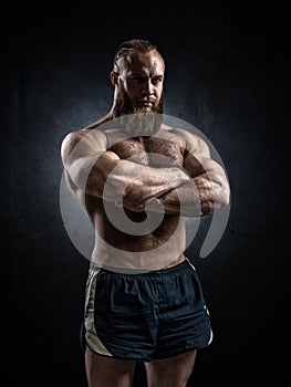 Bodybuilder topless over grunge background.