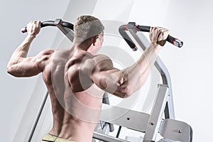 Bodybuilder training in the gym. Athlete doing