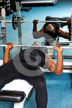 Bodybuilder trying to lift the barbell