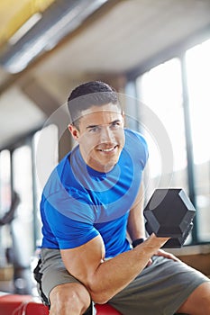 Bodybuilder, weight lifting and man with workout portrait in gym with dumbbell, exercise challenge and strong muscle