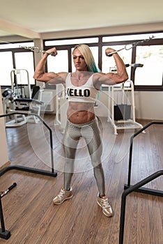 Bodybuilder Woman Doing Heavy Weight Exercise For Biceps