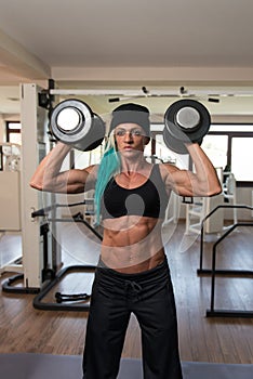 Bodybuilder Woman Doing Heavy Weight Exercise For Shoulders
