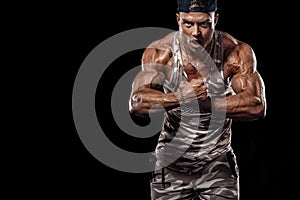 Bodybuilding competitions on the scene. Man sportsmen physique and athlete. Black background.