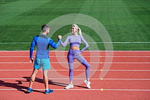 bodybuilding. help and support. fit sporty people. man and woman sport trainer. fitness couple training outdoor. gesture