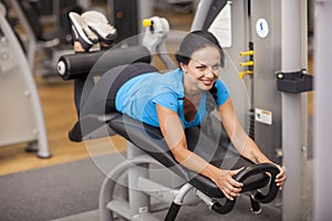 Bodybuilding. woman exercising in gym with exercise-machine