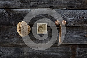 Bodycare and massage products over rustic wood background, top view