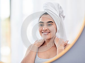 A bodycare routine is a great way to relive stress. attractive young woman admiring herself in the mirror.