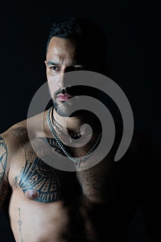 Bodycare or wellness and sport. Bearded man with tattooed chest. Man with muscular torso. Fit model with tattoo