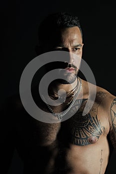 Bodycare or wellness and sport. Bearded man with tattooed chest. Man with sexy muscular torso. Fit model with tattoo