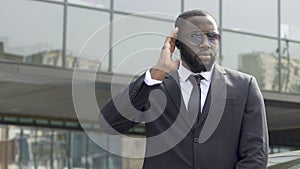 Bodyguard awaiting appearance of governmental motorcade inspecting territory