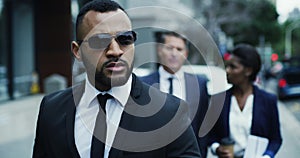 Bodyguard, business team walking in the city streets together with bodyguard black suits. Safety or safe keeping