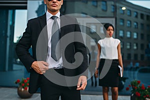 Bodyguard in suit and sunglasses, female VIP photo