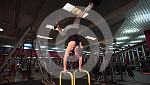Bodyweight exercise, man standing on hands at gym