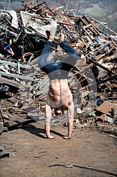 Bodyweight Training Man Standing on Hands in Junkyard